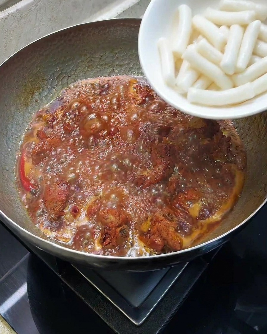 갈비 조림에 떡을 넣어 익히는 모습.