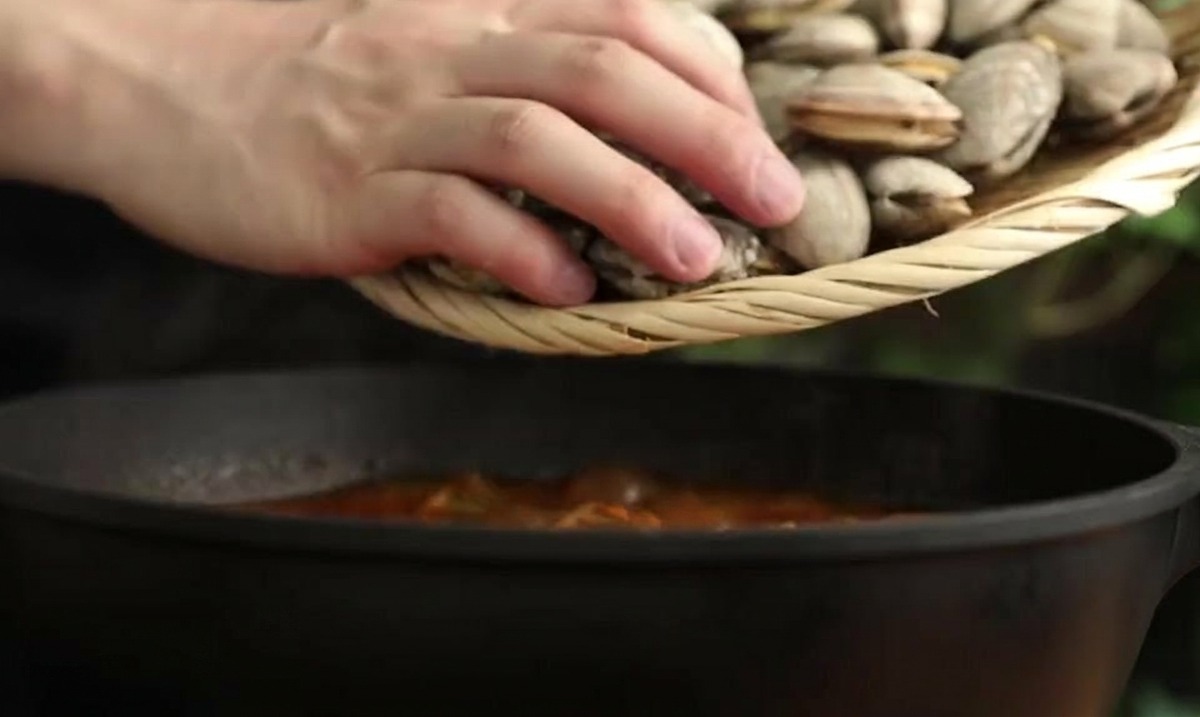 해감을 마친 바지락을 찌개 냄비에 골고루 넣는 모습.