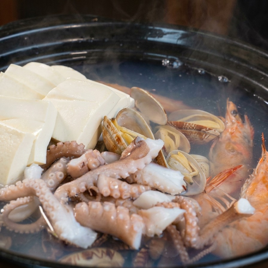 납작하게 썬 무와 당근을 냄비에 추가하는 장면.