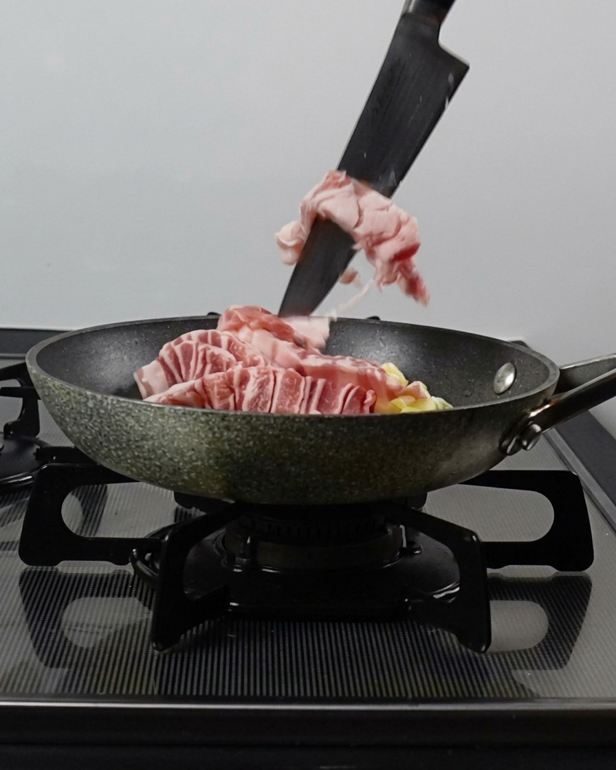 팬에 삼겹살, 다진 대파, 마늘을 넣는 모습