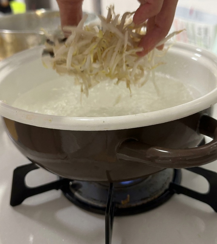 팔팔 끓는 물에 신선한 숙주나물을 넣는 모습.