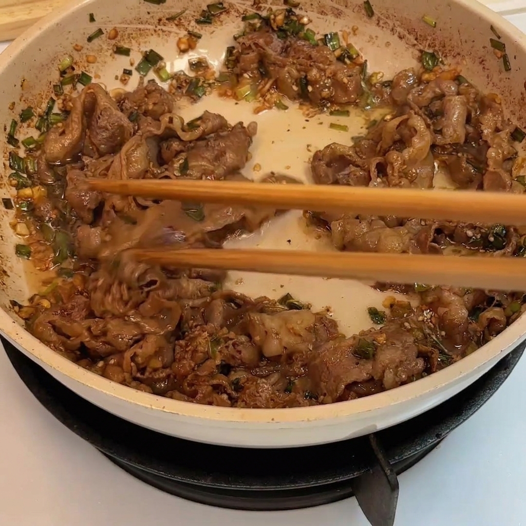 갈색빛으로 먹음직스럽게 익어가는 소고기 볶음.