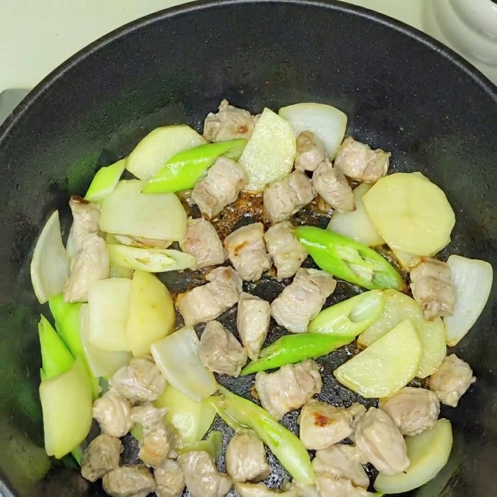 볶아진 고기에 김치를 넣고 함께 볶는 모습.