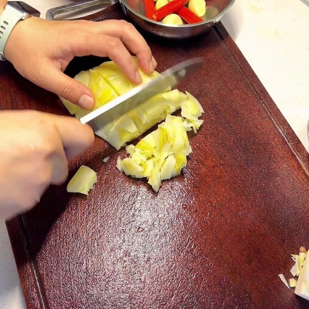 도마 위에서 김치를 먹기 좋은 크기로 써는 모습.