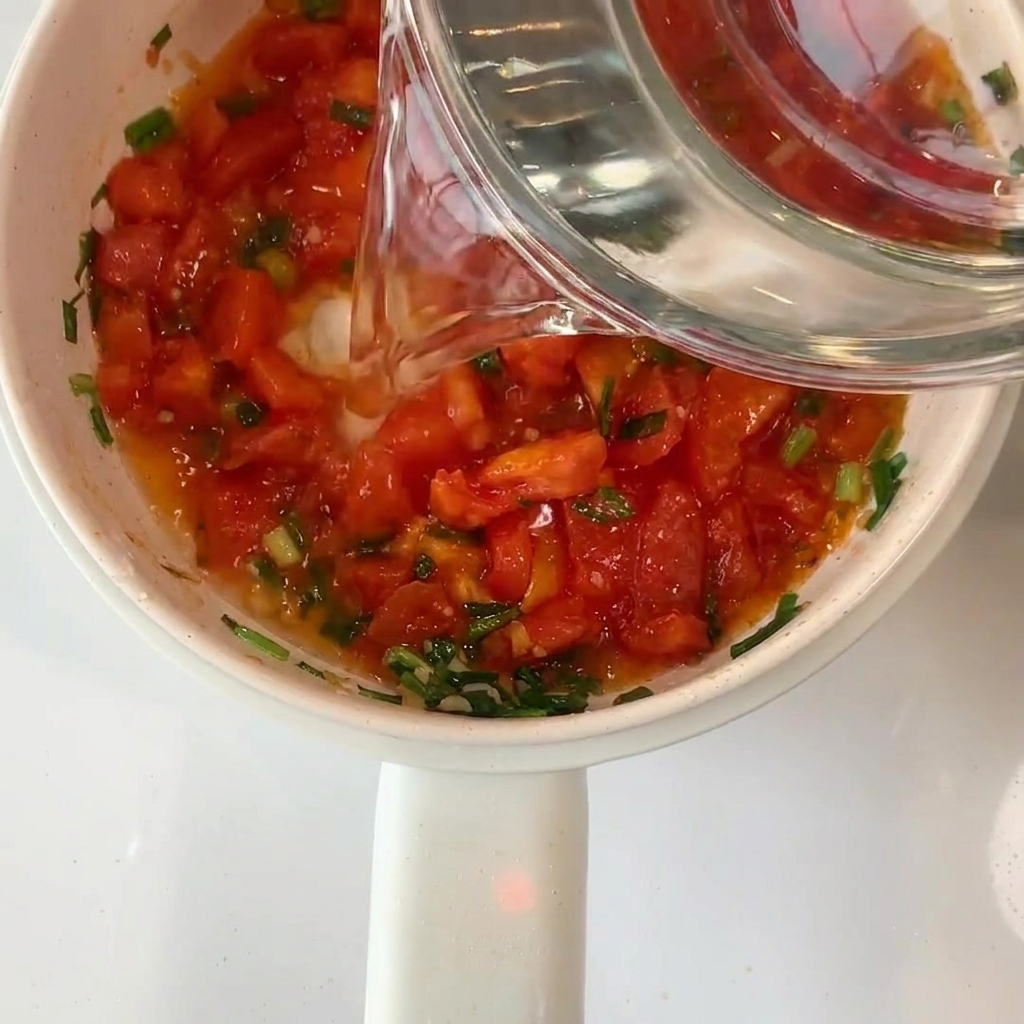 볶은 토마토 재료에 물을 붓는 모습