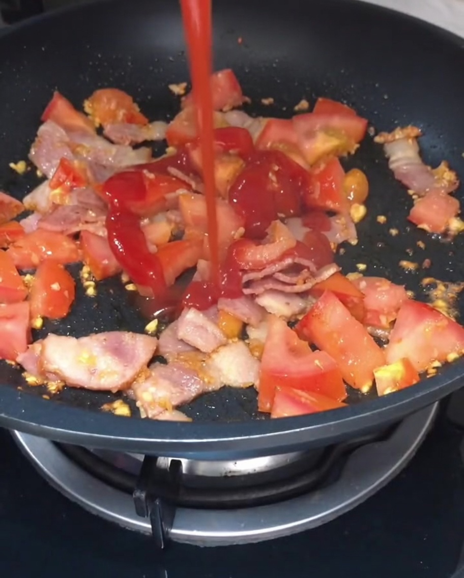 토마토와 베이컨 볶음 위에 뿌려지는 케첩과 간장.