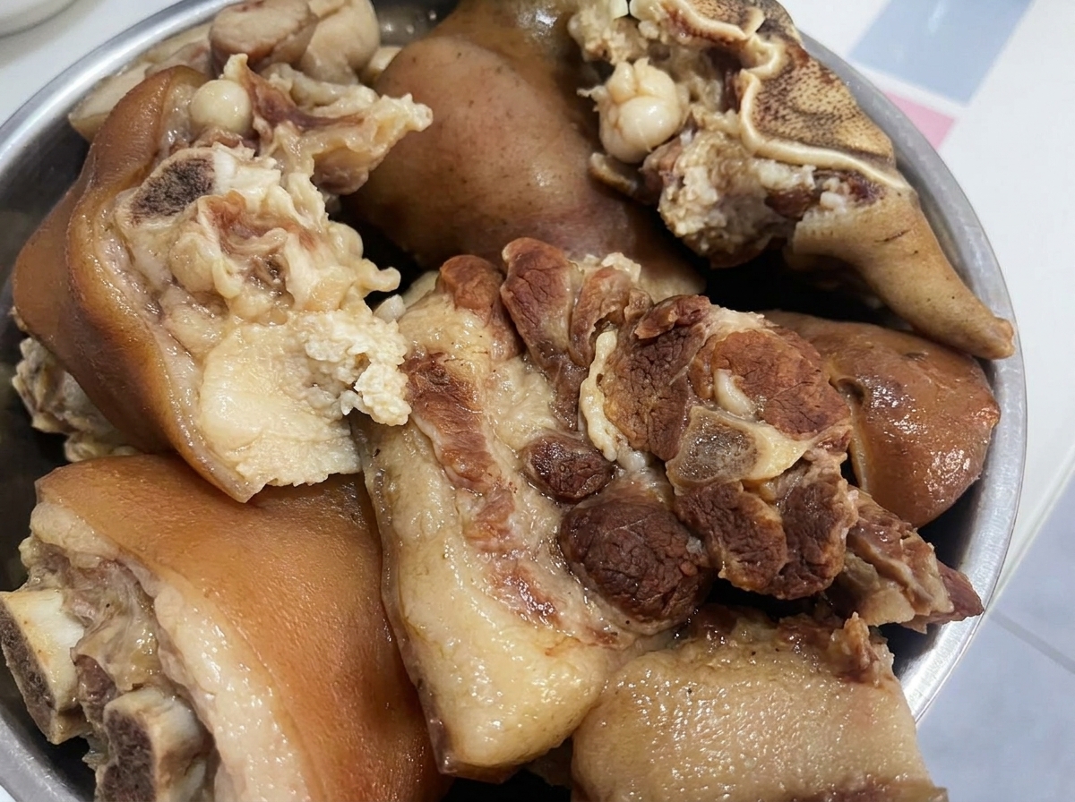 더 작은 크기로 썰 준비가 된 채 볼에 담겨 있는 익힌 돼지고기 조각들.