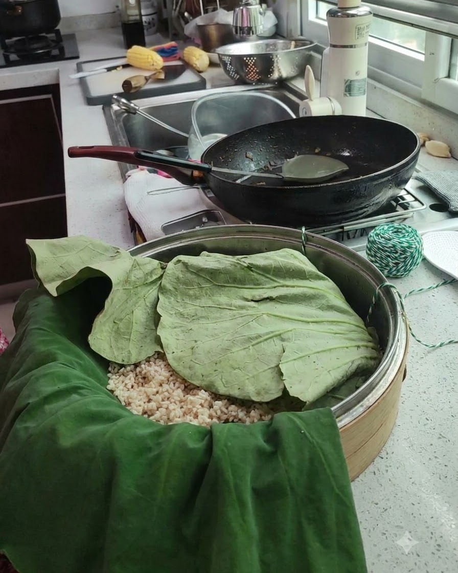 찜기 안에 놓인 연잎 쌈 패키지와 초록색 및 흰색 요리용 실의 모습.